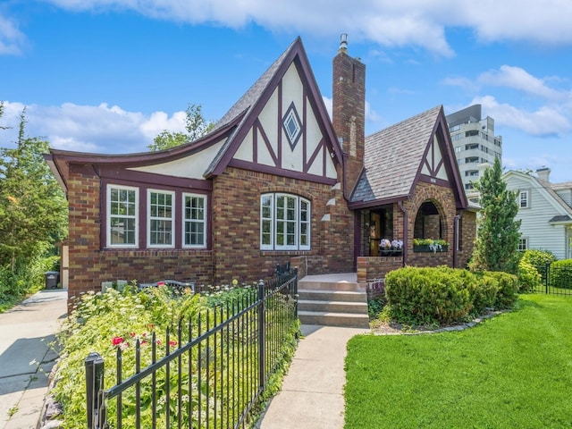 3826 Grand Ave, Des Moines, IA 50312 - english style home featuring brick siding, a chimney, stucco siding, and a porch