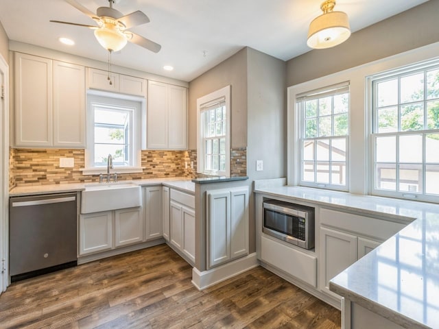 3826 Grand Ave, Des Moines, IA 50312 - kitchen with stainless steel appliances, healthy amount of natural light, backsplash, dark wood-style floors, and recessed lighting