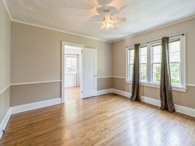 3826 Grand Ave, Des Moines, IA 50312 - spare room featuring light wood-style flooring, ceiling fan, and ornamental molding