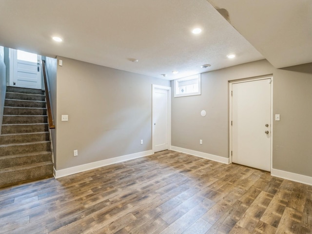 3826 Grand Ave, Des Moines, IA 50312 - below grade area with wood finished floors, recessed lighting, and stairway