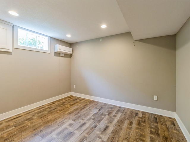 3826 Grand Ave, Des Moines, IA 50312 - below grade area with a wall mounted air conditioner, wood finished floors, and recessed lighting