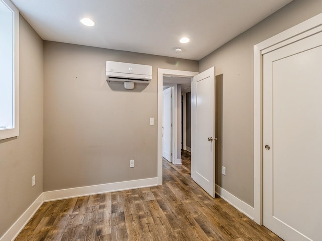 3826 Grand Ave, Des Moines, IA 50312 - unfurnished room featuring a wall mounted AC, wood finished floors, and recessed lighting