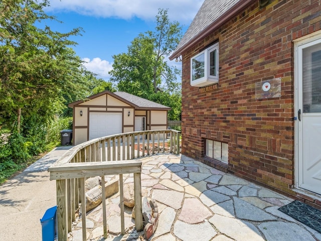 3826 Grand Ave, Des Moines, IA 50312 - view of patio featuring an outbuilding and a garage
