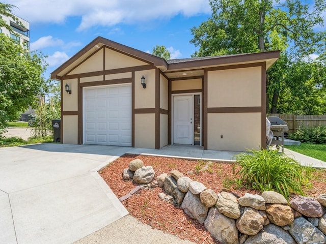 3826 Grand Ave, Des Moines, IA 50312 - view of front facade featuring an attached garage, stucco siding, and concrete driveway