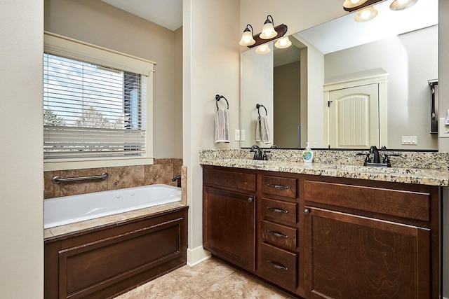 full bath with double vanity, a garden tub, tile patterned floors, and a sink