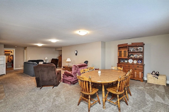 carpeted dining area with a textured ceiling