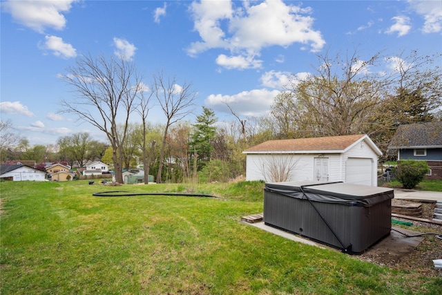 1804 E 33rd St, Des Moines, IA 50317 - view of green lawn with a hot tub, a detached garage, and an outbuilding