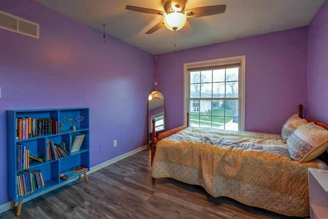 310 E Emma Ave, Des Moines, IA 50315 - bedroom with wood finished floors, baseboards, and a ceiling fan