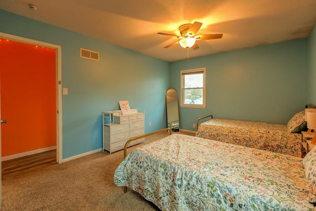 310 E Emma Ave, Des Moines, IA 50315 - carpeted bedroom featuring baseboards and ceiling fan