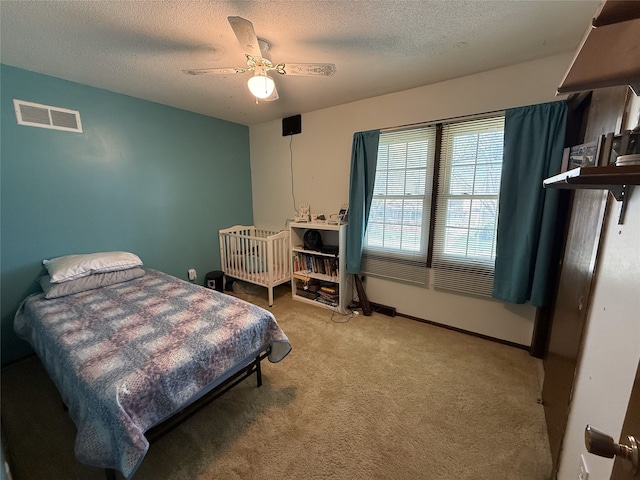 210 11th Ave SW, Altoona, IA 50009 - bedroom with carpet, a textured ceiling, ceiling fan, and baseboards