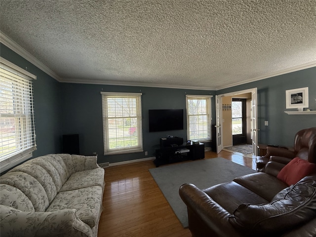 210 11th Ave SW, Altoona, IA 50009 - living area with a textured ceiling, wood finished floors, ornamental molding, plenty of natural light, and baseboards