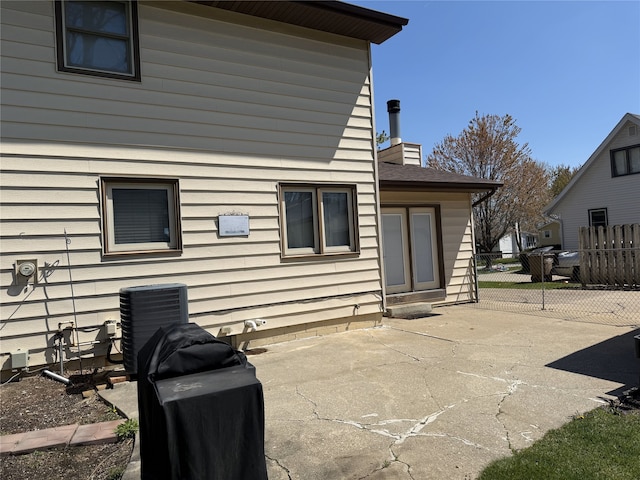 210 11th Ave SW, Altoona, IA 50009 - back of property featuring a chimney, a patio, and central AC unit