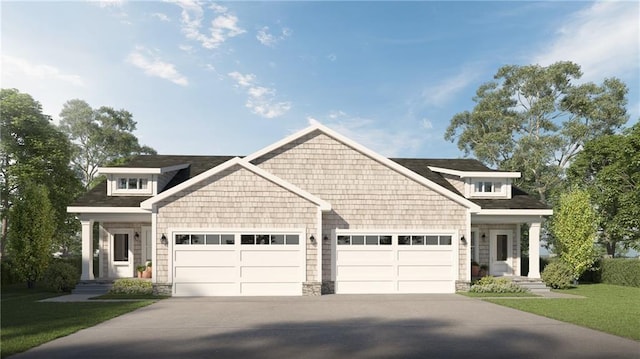 craftsman-style house with a front lawn, driveway, and a garage