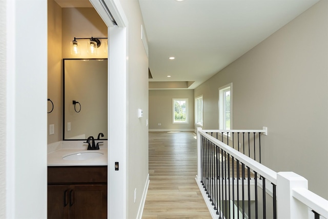 1204 Westview Dr, Huxley, IA 50124 - hall with a sink, light wood-type flooring, an upstairs landing, recessed lighting, and baseboards