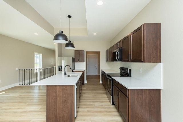 1204 Westview Dr, Huxley, IA 50124 - kitchen featuring stainless steel appliances, a sink, light countertops, baseboards, and recessed lighting