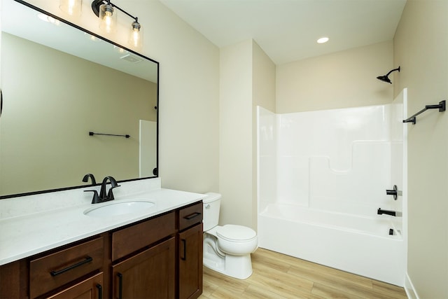 1206 Westview Dr, Huxley, IA 50124 - full bathroom featuring toilet, vanity, wood finished floors, tub / shower combination, and recessed lighting