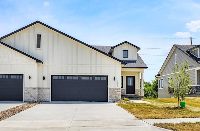 1206 Westview Dr, Huxley, IA 50124 - modern inspired farmhouse with stone siding, a garage, concrete driveway, board and batten siding, and roof with shingles