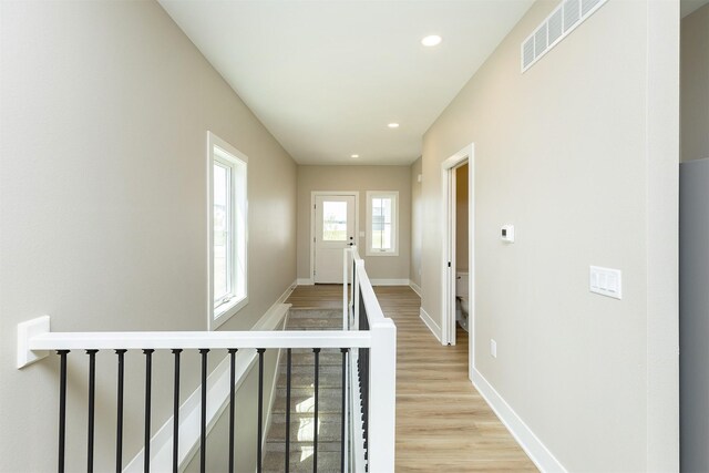 1206 Westview Dr, Huxley, IA 50124 - hall with an upstairs landing, light wood finished floors, baseboards, and recessed lighting