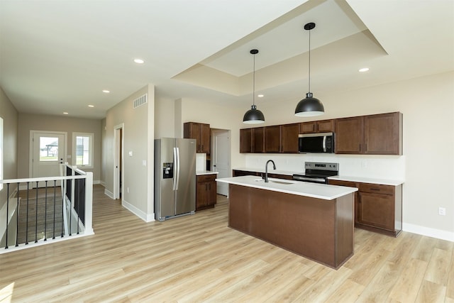 1206 Westview Dr, Huxley, IA 50124 - kitchen featuring stainless steel appliances, light wood-style floors, baseboards, a sink, and light countertops