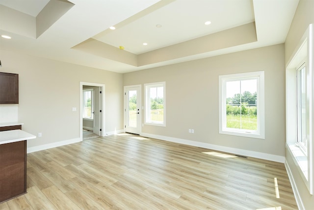 1208 Westview Dr, Huxley, IA 50124 - unfurnished living room featuring light wood-style flooring, a raised ceiling, baseboards, and recessed lighting