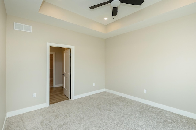 1208 Westview Dr, Huxley, IA 50124 - empty room featuring carpet, a ceiling fan, baseboards, recessed lighting, and a tray ceiling