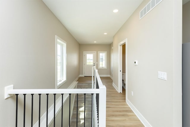1208 Westview Dr, Huxley, IA 50124 - hall with an upstairs landing, light wood finished floors, baseboards, and recessed lighting