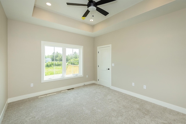 1208 Westview Dr, Huxley, IA 50124 - spare room with carpet floors, baseboards, ceiling fan, a raised ceiling, and recessed lighting