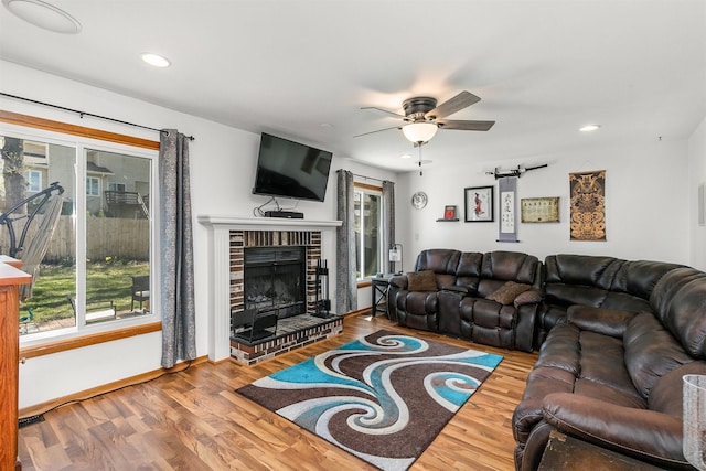 4830 70th Pl, Urbandale, IA 50322 - living room featuring wood finished floors, a ceiling fan, baseboards, a fireplace, and recessed lighting