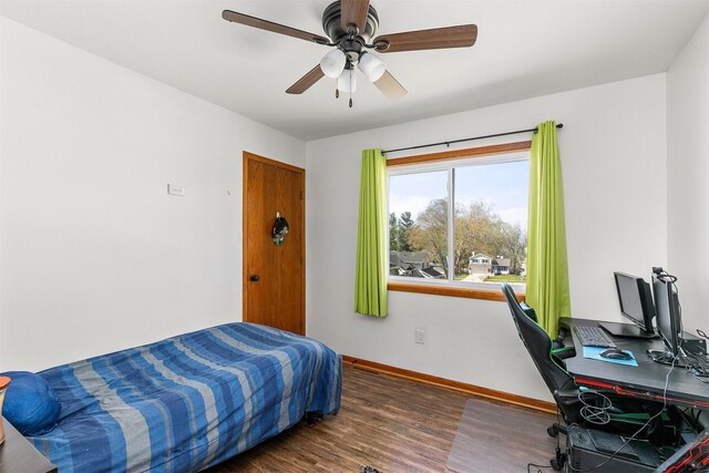 4830 70th Pl, Urbandale, IA 50322 - bedroom featuring baseboards, wood finished floors, an office area, and ceiling fan