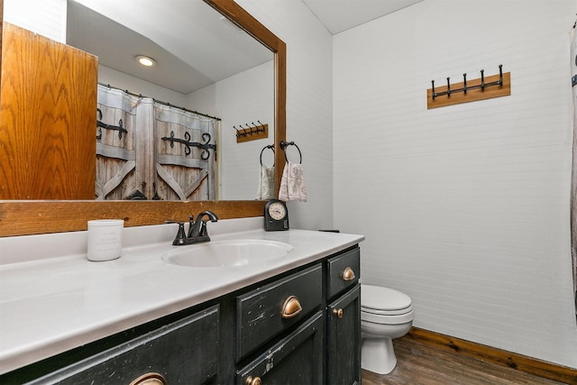 4830 70th Pl, Urbandale, IA 50322 - bathroom with toilet, vanity, and wood finished floors