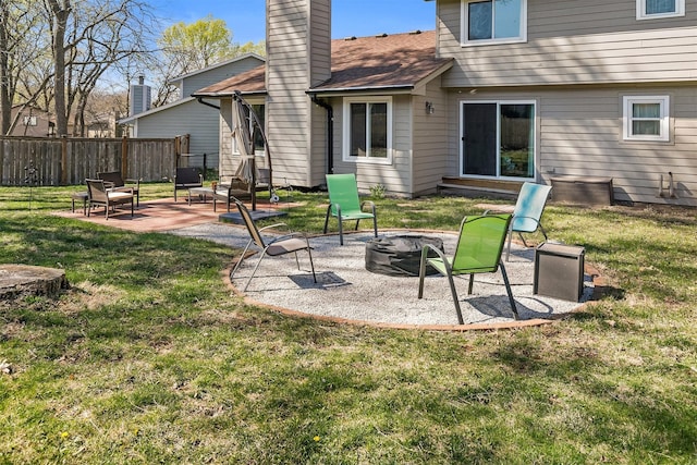 4830 70th Pl, Urbandale, IA 50322 - back of house featuring a fire pit, a patio area, and a chimney