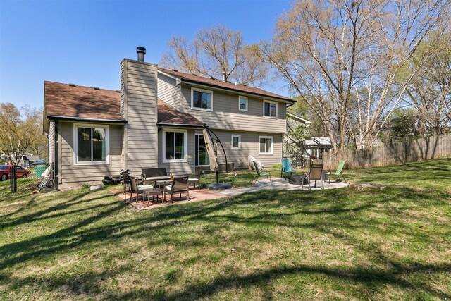 4830 70th Pl, Urbandale, IA 50322 - rear view of property with a fire pit, a patio, and a chimney