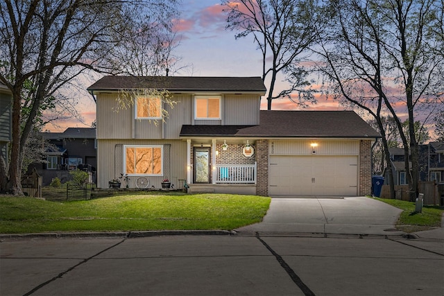 4830 70th Pl, Urbandale, IA 50322 - traditional home featuring concrete driveway, a lawn, a garage, and brick siding