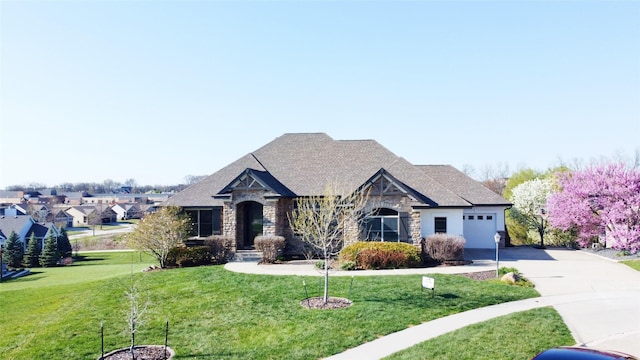 9289 Winterberry Ct, West Des Moines, IA 50266 - view of front of property featuring driveway, stone siding, an attached garage, a front yard, and roof with shingles