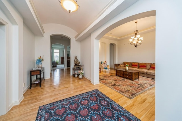 9289 Winterberry Ct, West Des Moines, IA 50266 - foyer featuring light wood finished floors, arched walkways, a notable chandelier, and lofted ceiling