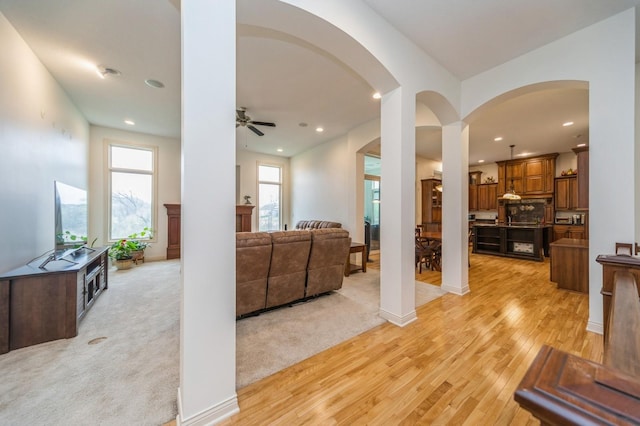 9289 Winterberry Ct, West Des Moines, IA 50266 - living room featuring recessed lighting, arched walkways, a ceiling fan, and light wood-type flooring