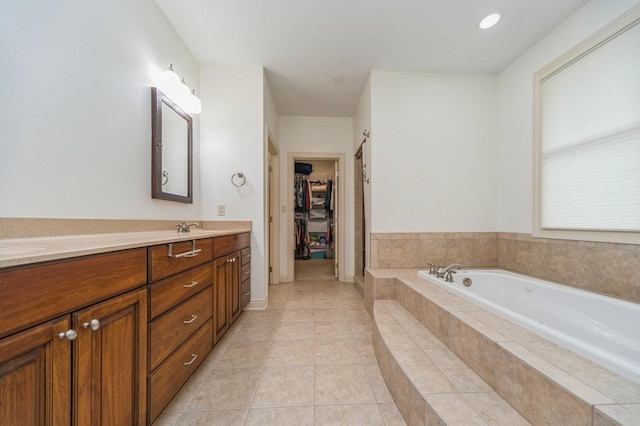 9289 Winterberry Ct, West Des Moines, IA 50266 - full bathroom featuring tile patterned flooring, double vanity, a sink, a walk in closet, and a bath