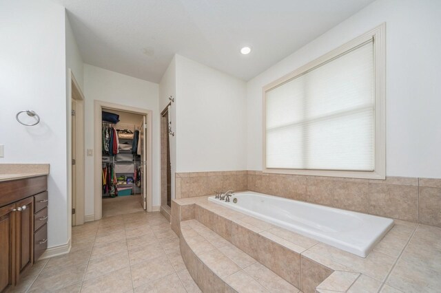 9289 Winterberry Ct, West Des Moines, IA 50266 - bathroom with tile patterned flooring, a shower stall, a garden tub, vanity, and a walk in closet