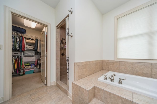 9289 Winterberry Ct, West Des Moines, IA 50266 - full bathroom with a bath, a spacious closet, tile patterned flooring, and a stall shower