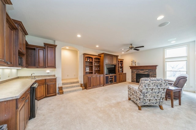 9289 Winterberry Ct, West Des Moines, IA 50266 - living area featuring recessed lighting, a stone fireplace, a ceiling fan, and light colored carpet