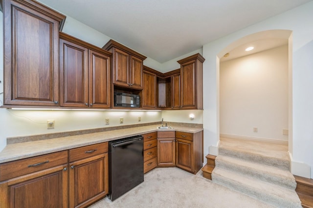 9289 Winterberry Ct, West Des Moines, IA 50266 - kitchen with light colored carpet, black appliances, arched walkways, and light countertops
