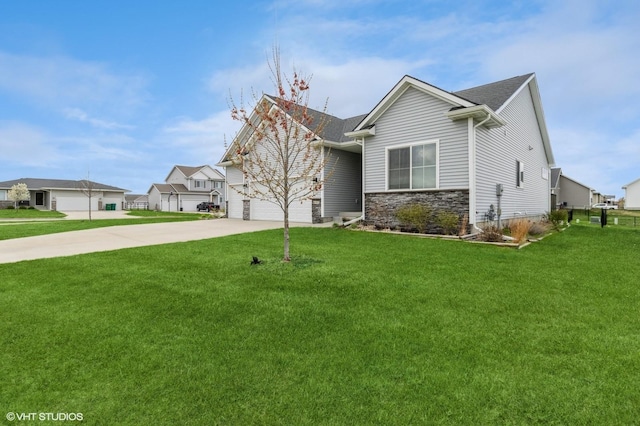 4901 NW 15th St, Ankeny, IA 50023 - view of front of home featuring a garage, driveway, stone siding, and a front yard
