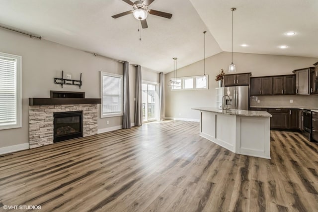 4901 NW 15th St, Ankeny, IA 50023 - kitchen with open floor plan, dark brown cabinetry, a ceiling fan, wood finished floors, and stainless steel refrigerator with ice dispenser