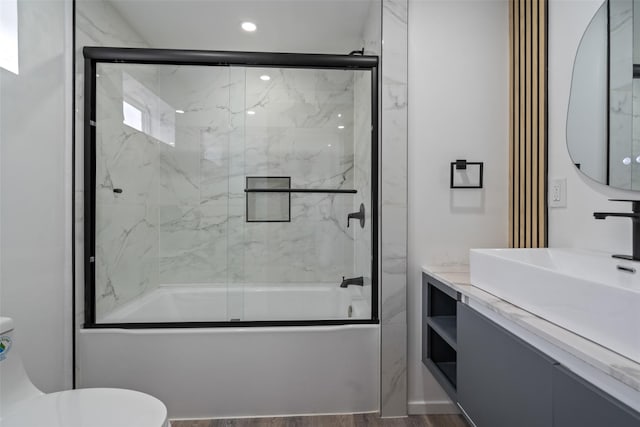 312 N 3rd Ave, Marshalltown, IA 50158 - bathroom with combined bath / shower with glass door, toilet, and vanity