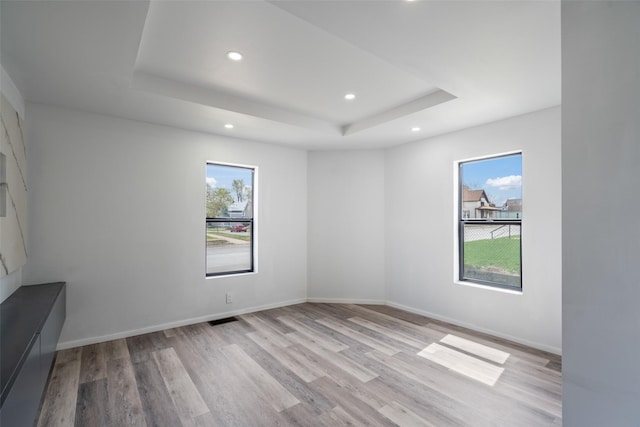 312 N 3rd Ave, Marshalltown, IA 50158 - unfurnished room with plenty of natural light, light wood-style flooring, recessed lighting, and a raised ceiling