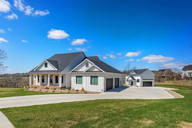 5094 Grand Ridge Dr, West Des Moines, IA 50265 - modern farmhouse style home with board and batten siding, a front yard, concrete driveway, an attached garage, and roof with shingles