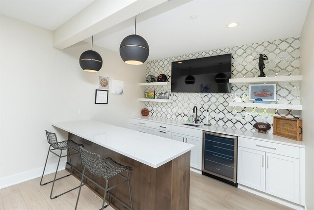 5094 Grand Ridge Dr, West Des Moines, IA 50265 - indoor wet bar featuring wine cooler, backsplash, light wood-style floors, pendant lighting, and recessed lighting