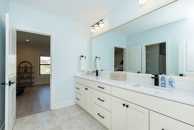 5094 Grand Ridge Dr, West Des Moines, IA 50265 - full bathroom featuring double vanity and baseboards