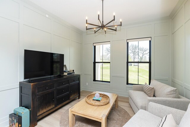 5094 Grand Ridge Dr, West Des Moines, IA 50265 - living room with a decorative wall, a chandelier, and light wood-style flooring