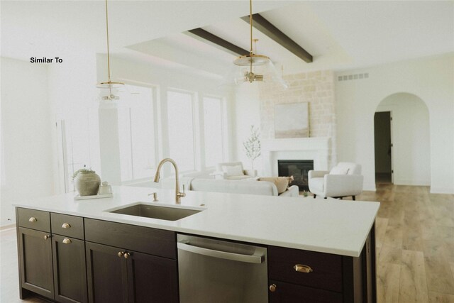 9015 Windsor Dr, Johnston, IA 50131 - kitchen with light countertops, visible vents, stainless steel dishwasher, a sink, and arched walkways